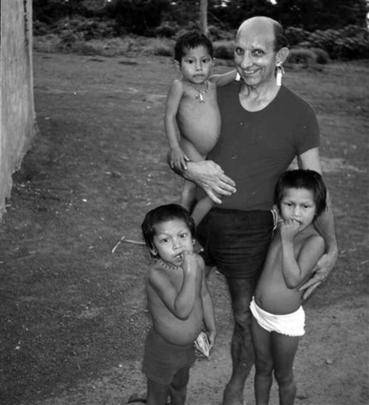 In this undated photo from a 2008 newsletter by the Bresciani missionaries, the Rev. Mario Pezzotti stands with Kayapo Indian children in Brazil. His was among 30 cases uncovered by the AP of priests accused of abuse who were transferred or moved abroad.
